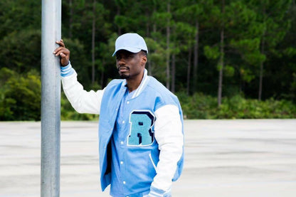 Jean Ribault Columbia Blue Melton Wool Letterman jacket with real cowhide white leather sleeves with a high quality chenille and felt 'R' Letter and Trojan Mascot patches for that true personalized look. this jacket has an inside semi zip-out quilt lining making it easy for you to add your own patches and embroidery if you desire. 